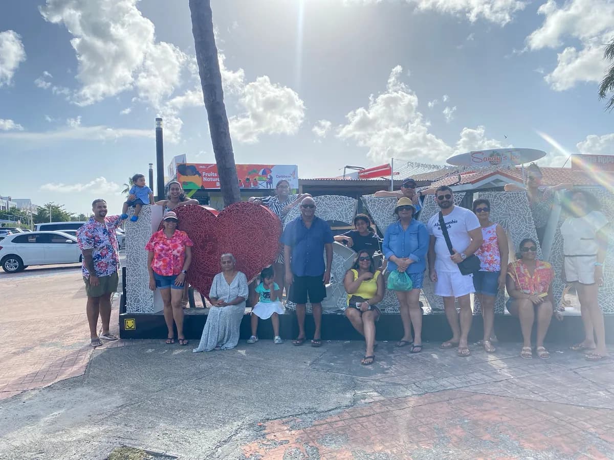 Tour group posing at the iconic heart sculpture in Philipsburg